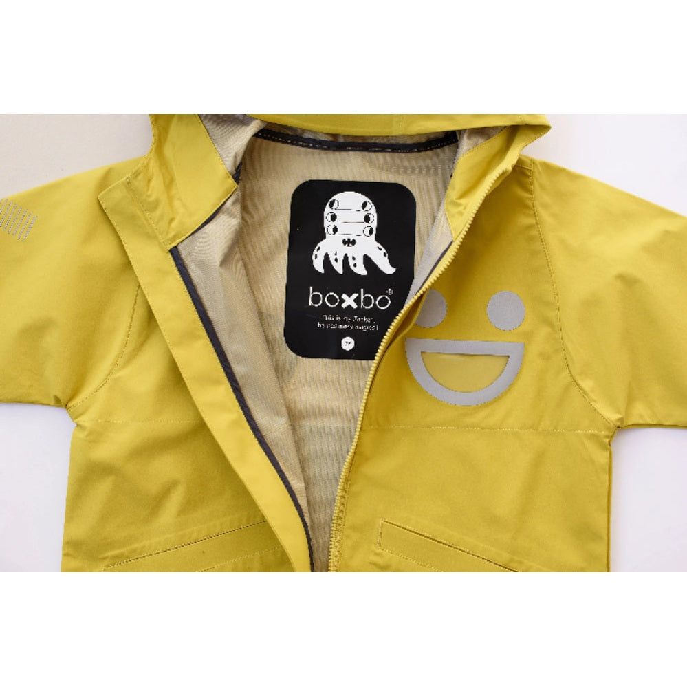 Boxbo Wistiti Windbreaker Rain Jacket Yellow for babies, zipper half-open and gray chest logo visible.