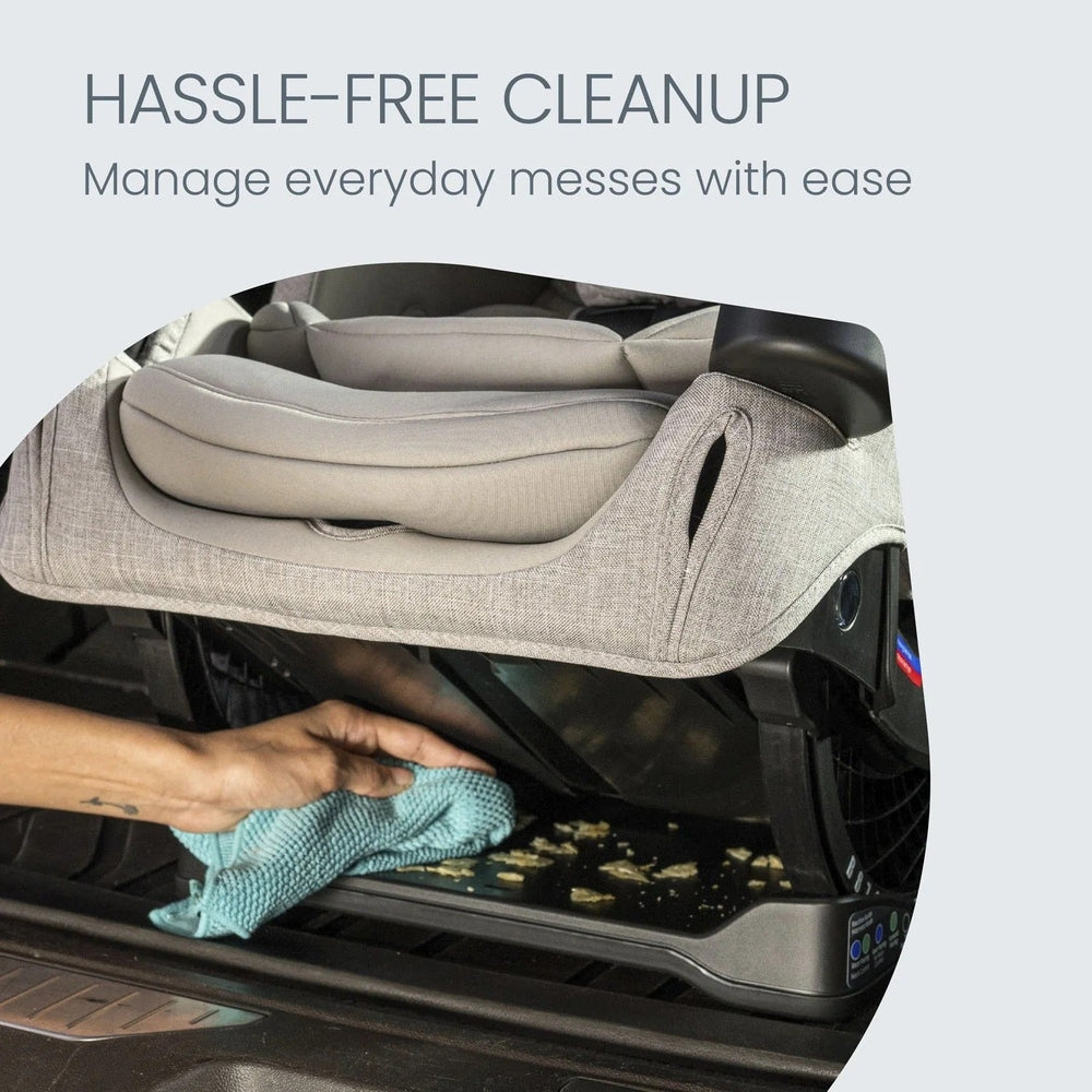 Britax One4Life Slim ClickTight All-in-One Car Seat in beige, being wiped clean with a microfiber cloth.