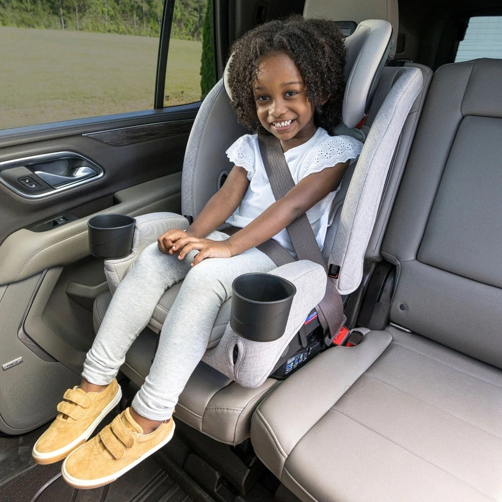 BRITAX One4Life Slim ClickTight All-in-One Car Seat in gray with dual cup holders as a smiling child buckles in.