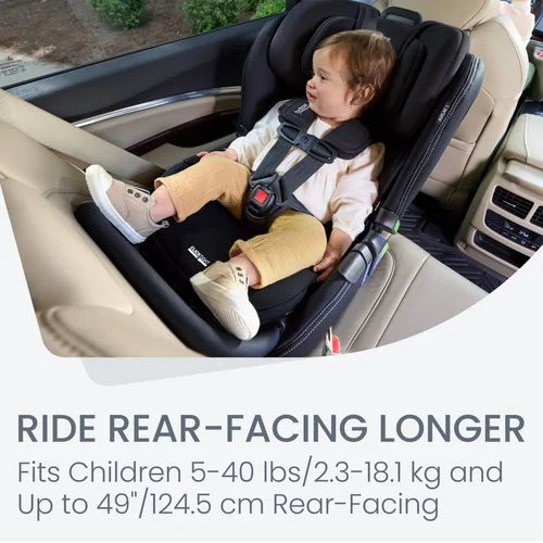 Britax Poplar S Convertible Car Seat in black, with a happy toddler buckled in rear-facing using the 5-point harness.