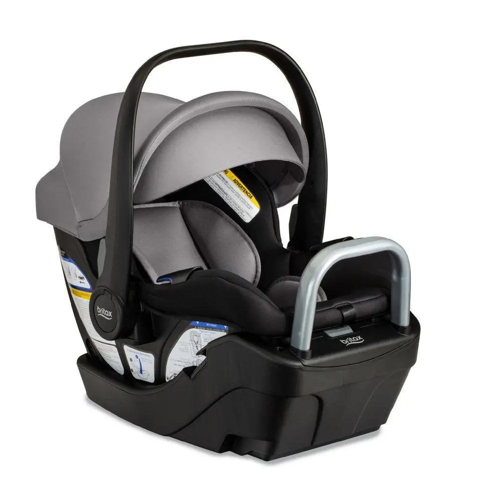Britax Willow S Infant Car Seat with base and gray fabric, shown with ergonomic carry handle for transport.