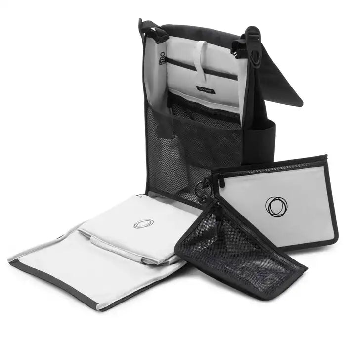 Bugaboo Changing Backpack diaper bag in black and gray, opened to show mesh pockets and organized changing mats.