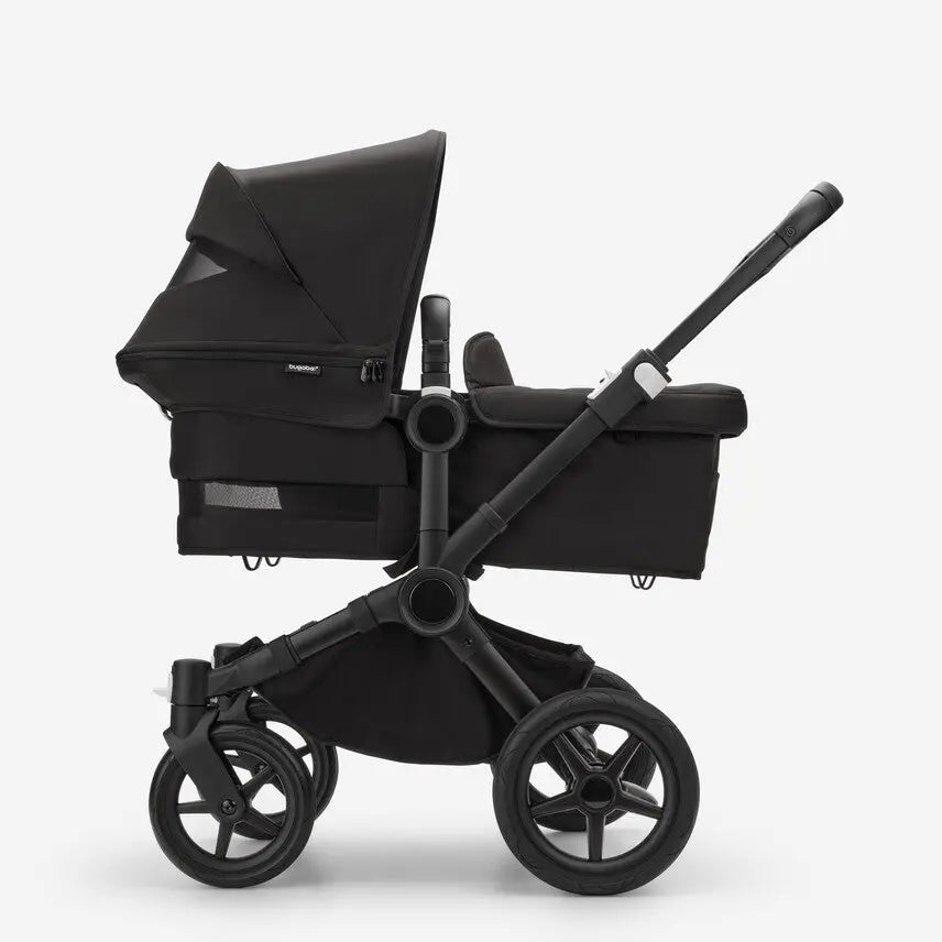 Bugaboo Donkey5 Mono Stroller Complete with bassinet in black, highlighting its all-terrain wheels.