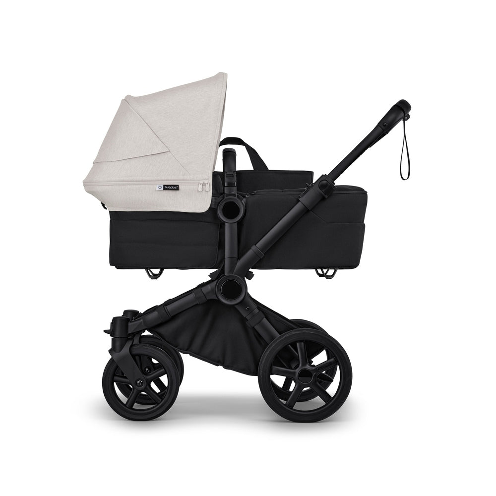 Bugaboo Donkey6 Mono Stroller in Beige with black frame and bassinet, side view.