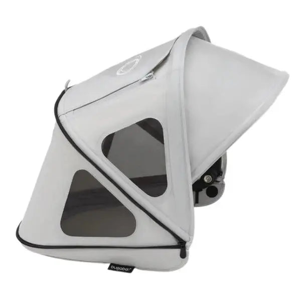 Bugaboo Dragonfly Breezy Sun Canopy in light gray with mesh windows, extended over a stroller.