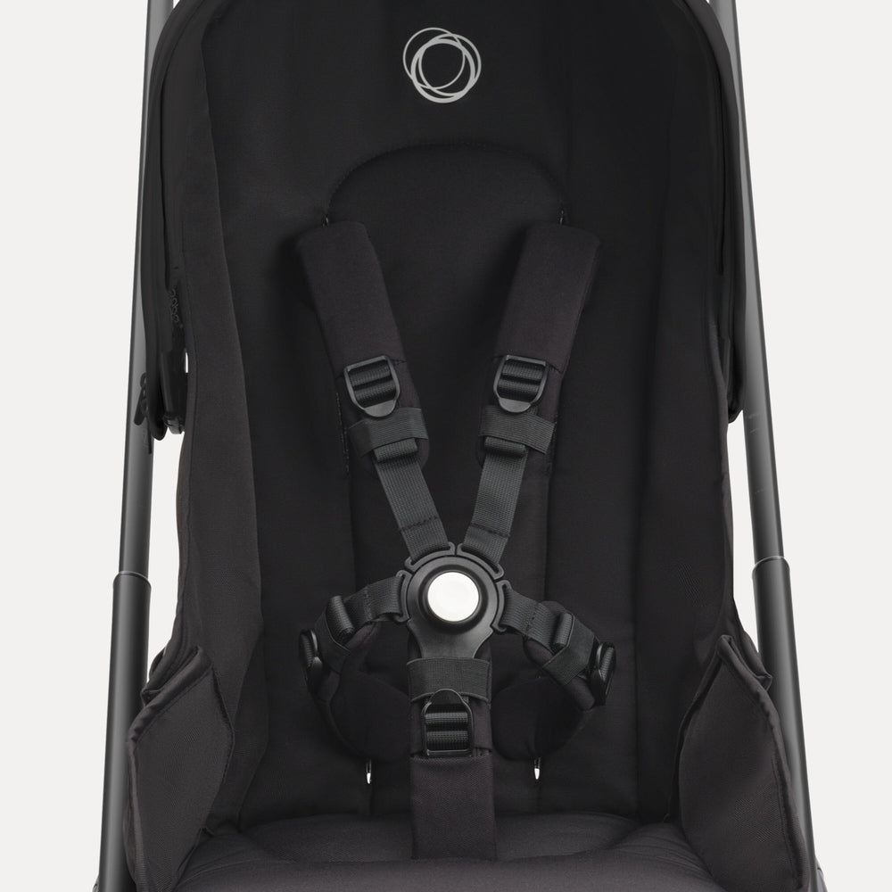 Bugaboo Dragonfly Stroller Complete in black, showing the secured 5-point harness with padded straps.