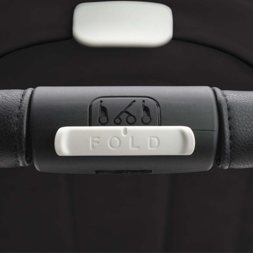 Bugaboo Dragonfly Stroller Complete, black handle with white FOLD lever shown in close-up.