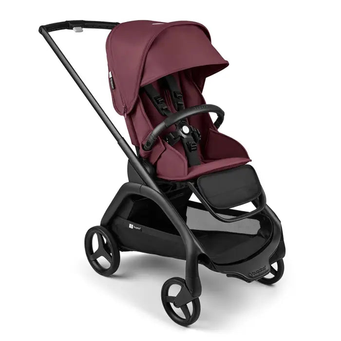 Bugaboo Dragonfly Stroller Complete in burgundy with black frame, canopy raised as parent strolls.