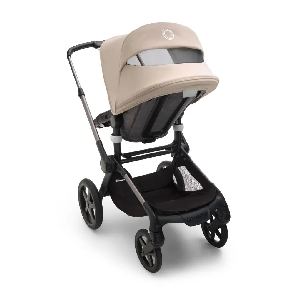 Bugaboo Fox 5 Sun Canopy in beige fitted on a Bugaboo stroller, shielding the seat with a sleek sunshade.