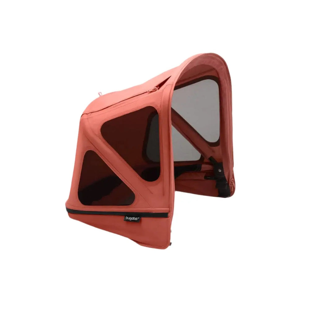 Bugaboo Donkey Breezy Sun Canopy in coral pink with dark mesh panels attached to a stroller frame.