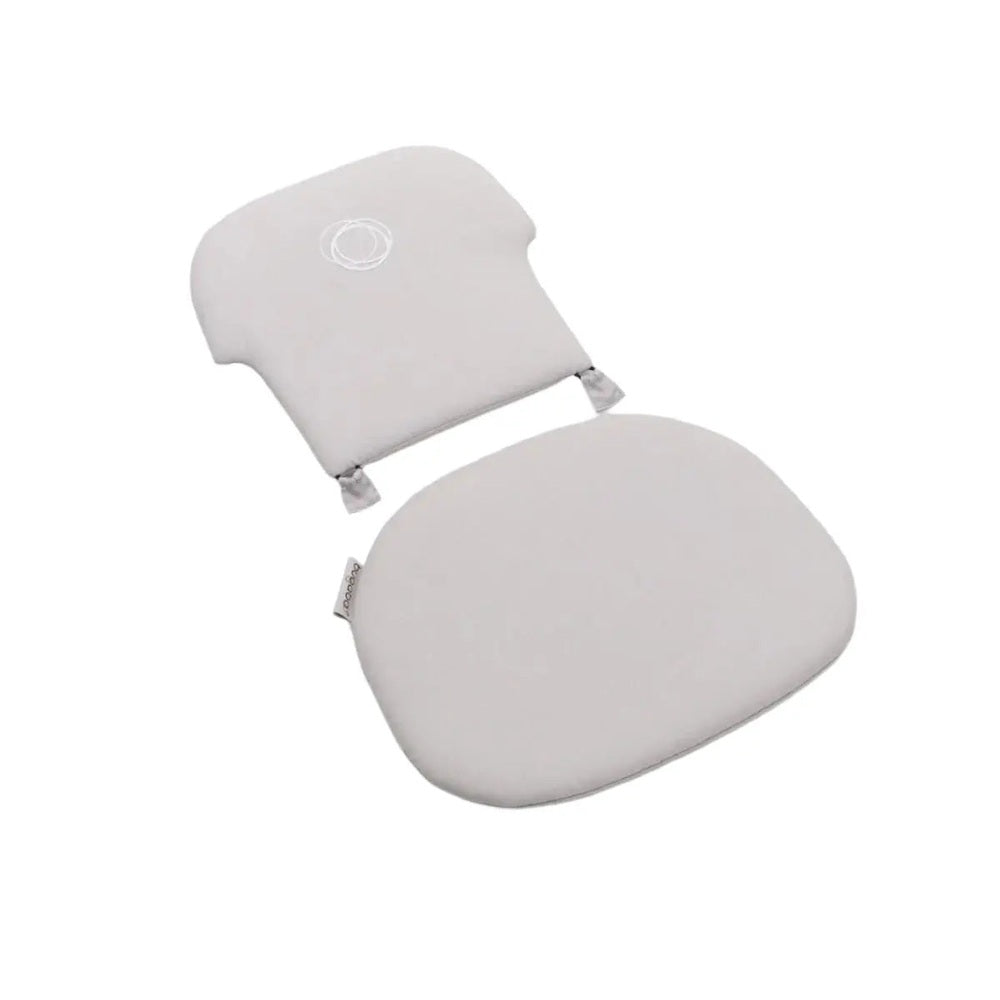 Bugaboo Giraffe Baby Pillow Set in light gray, two cushions supporting head and seating on a high chair.