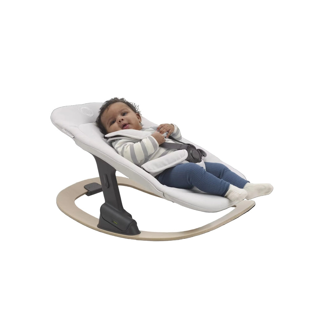 Bugaboo Giraffe Baby Rocker Rocker in White seat with natural wood base, side view.