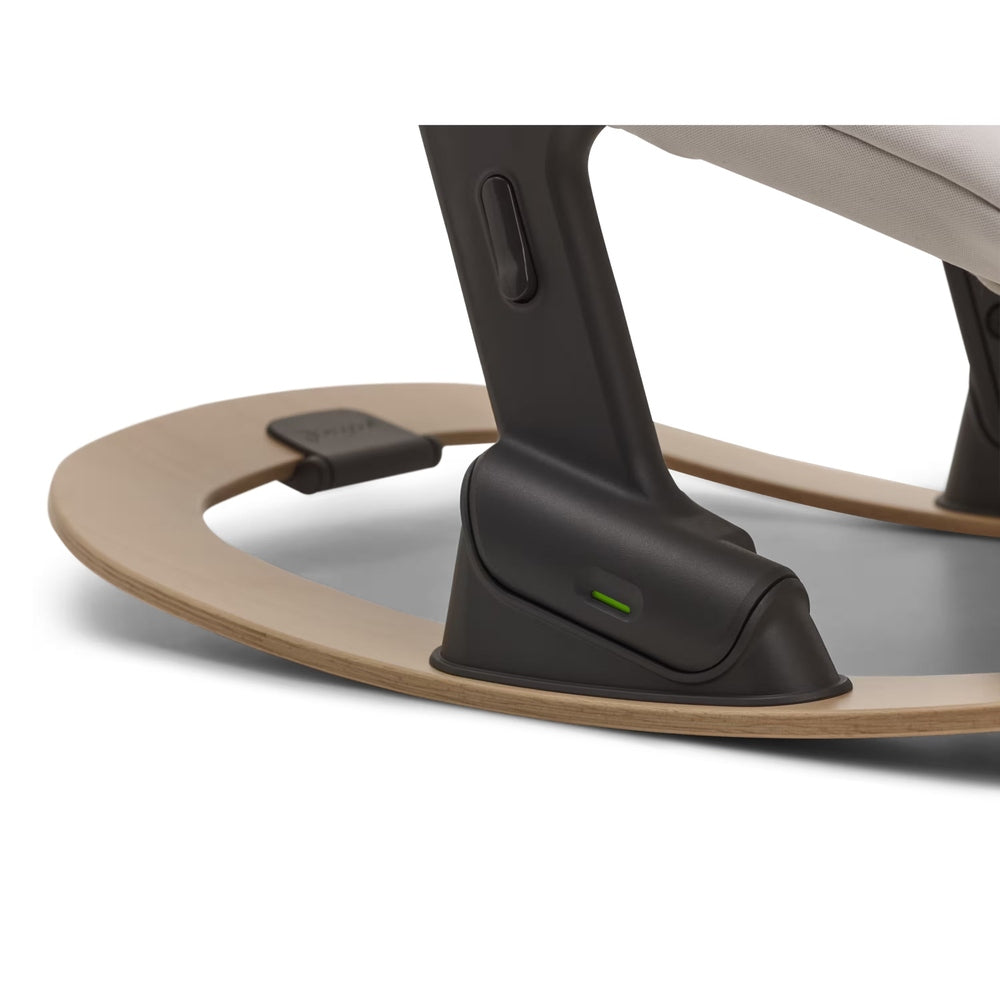 Bugaboo Giraffe Baby Rocker in dark gray frame with natural wood circular base.