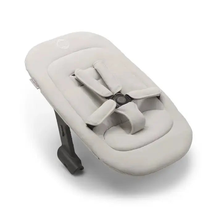 Bugaboo Giraffe Newborn Set high chair in light beige padded seat with a secured 5-point harness.