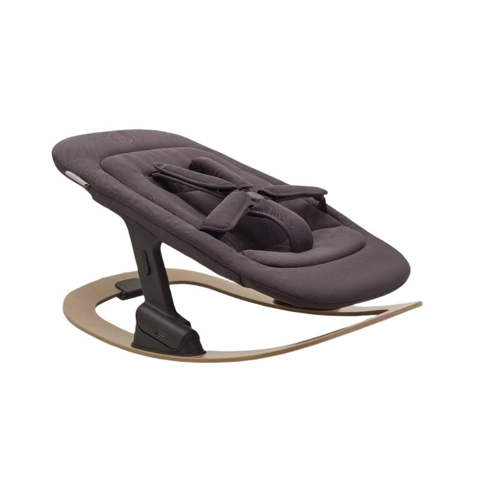 BUGABOO Giraffe Newborn Set high chair in charcoal fabric, securely strapped to a curved wooden base.