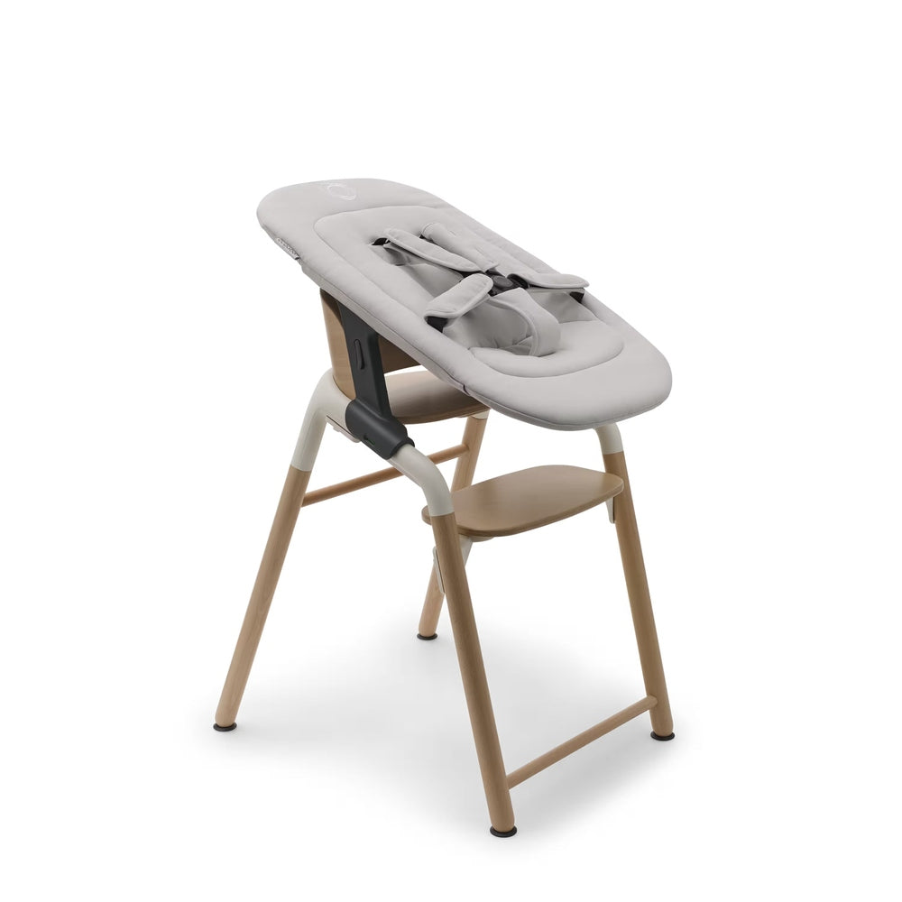 Bugaboo Giraffe Newborn Set in Light Gray padding with natural wood frame — side view