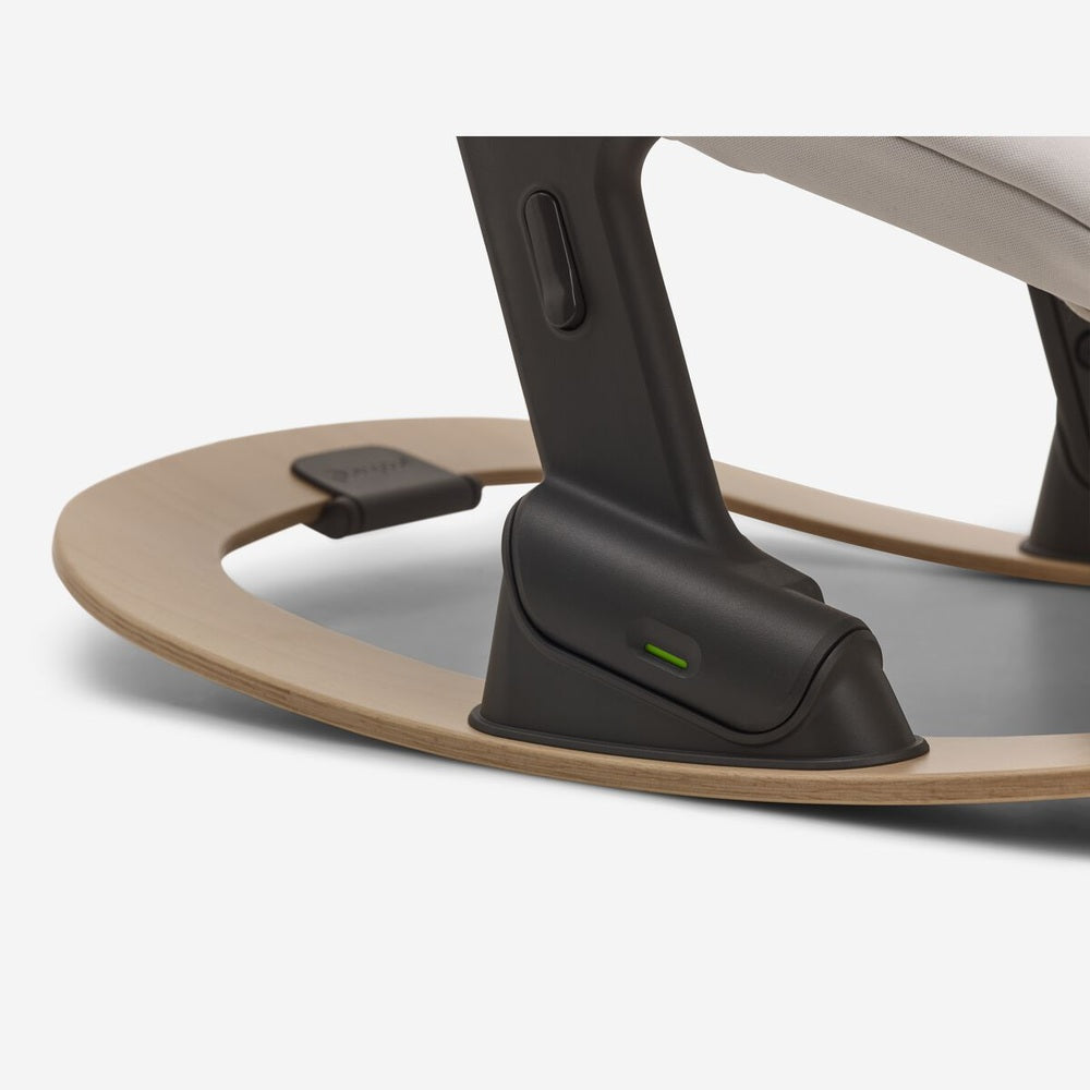 Bugaboo Giraffe rocker frame in neutral wood with black base and a green indicator