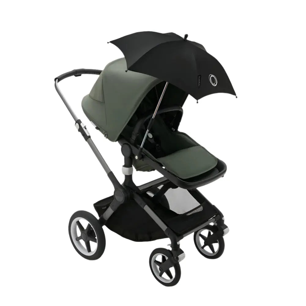 Bugaboo Parasol+ in black attached to a green BUGABOO stroller, shading the seating area.