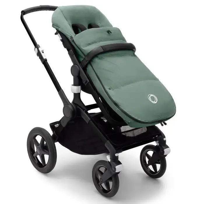Bugaboo Performance Winter Footmuff in green attached to stroller, showing padded, snug warmth for baby