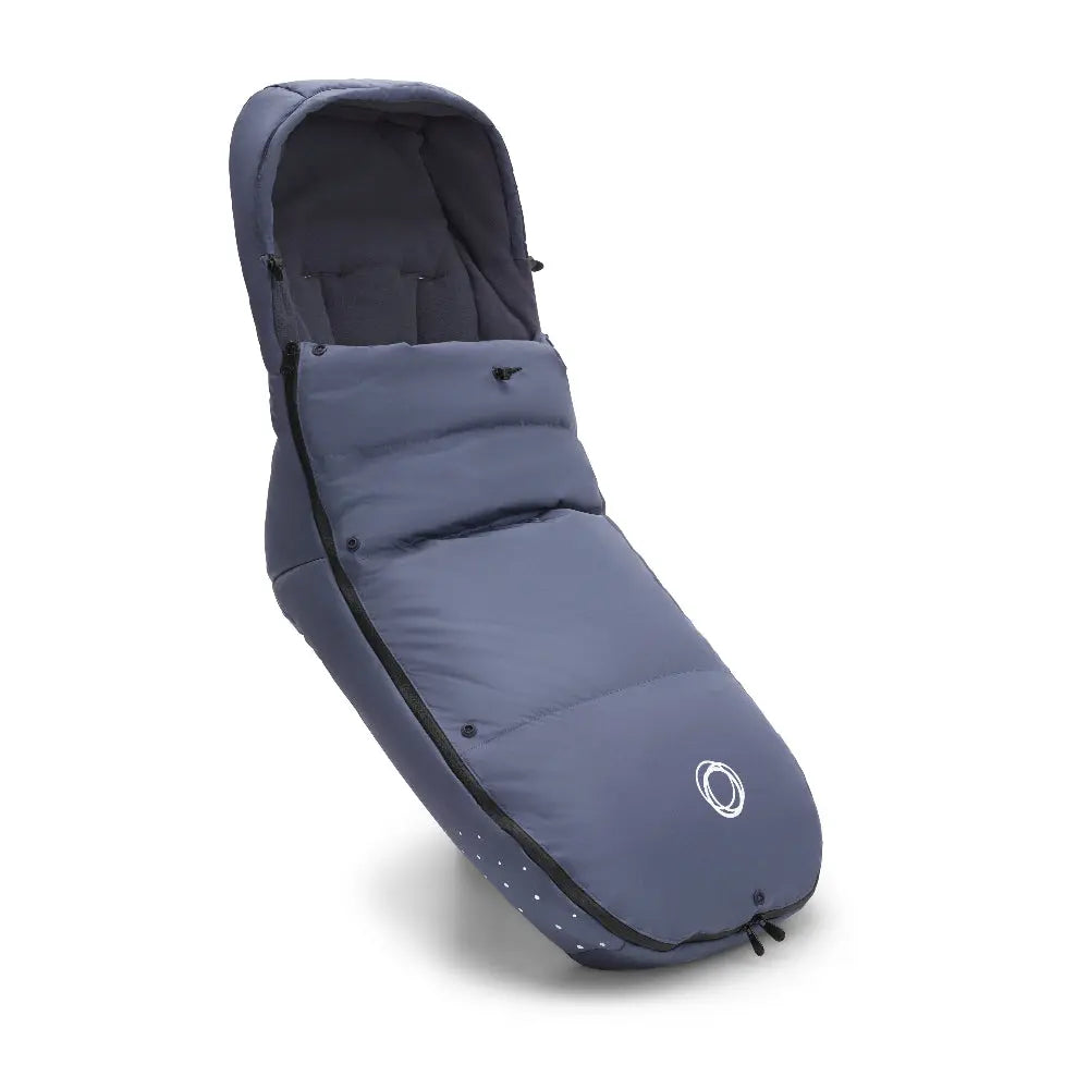 Bugaboo Performance Winter Footmuff in blue, padded with zipper opening, snugged to a stroller for warmth.