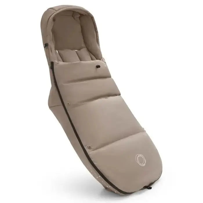 Bugaboo Performance Winter Footmuff beige, attached to a stroller with snug padded warmth and hood.