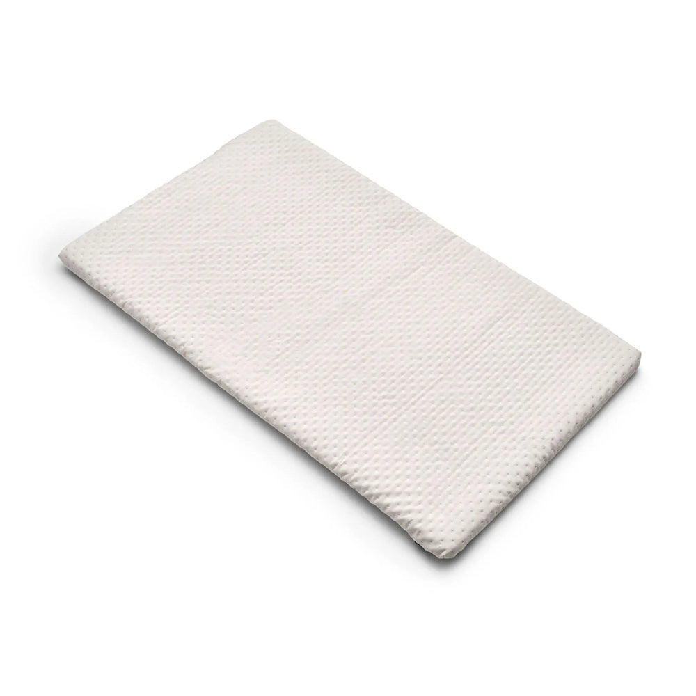 Bugaboo Stardust Playard mattress pad in white textured fabric providing a cozy, secure sleep space.