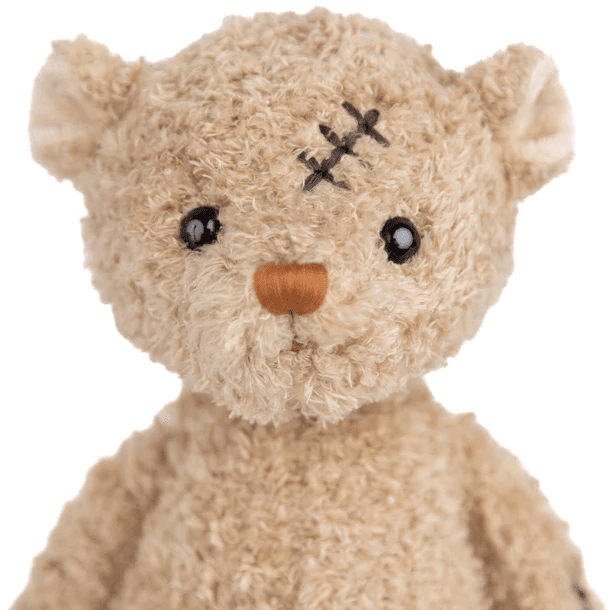 Bukowski Bears Nobody is Perfect stuffed animal bear in soft beige plush with stitched scar, close-up shot.