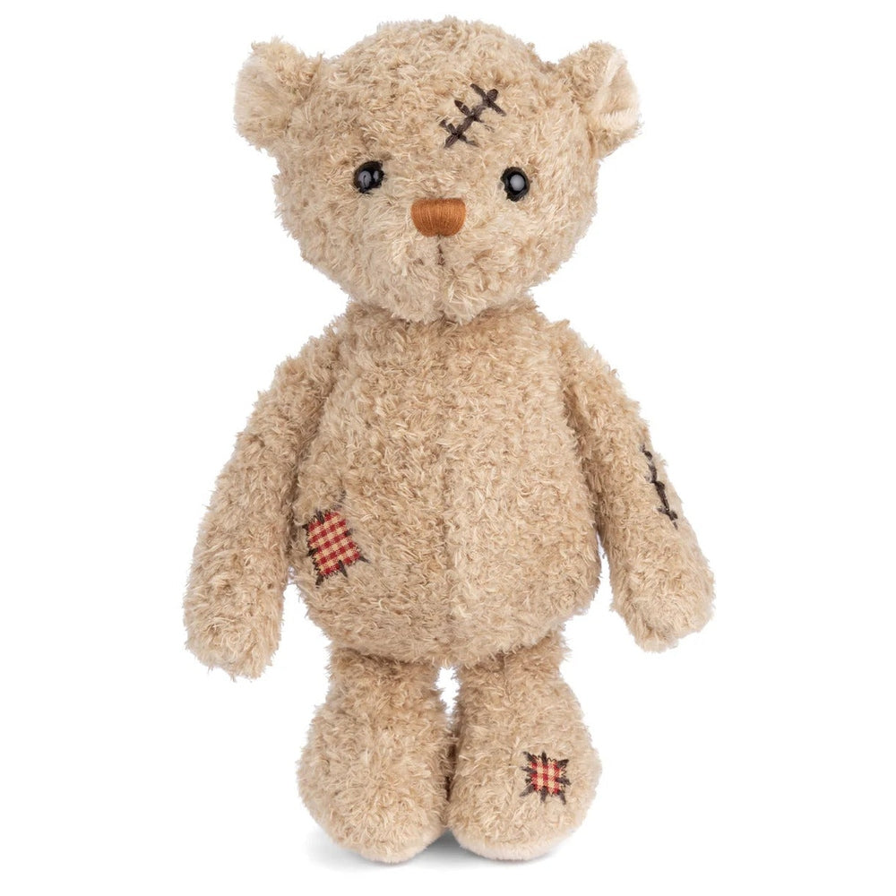 Bukowski Bears Nobody is Perfect stuffed animal teddy bear, beige plush with plaid patches, standing upright to show stitched details.