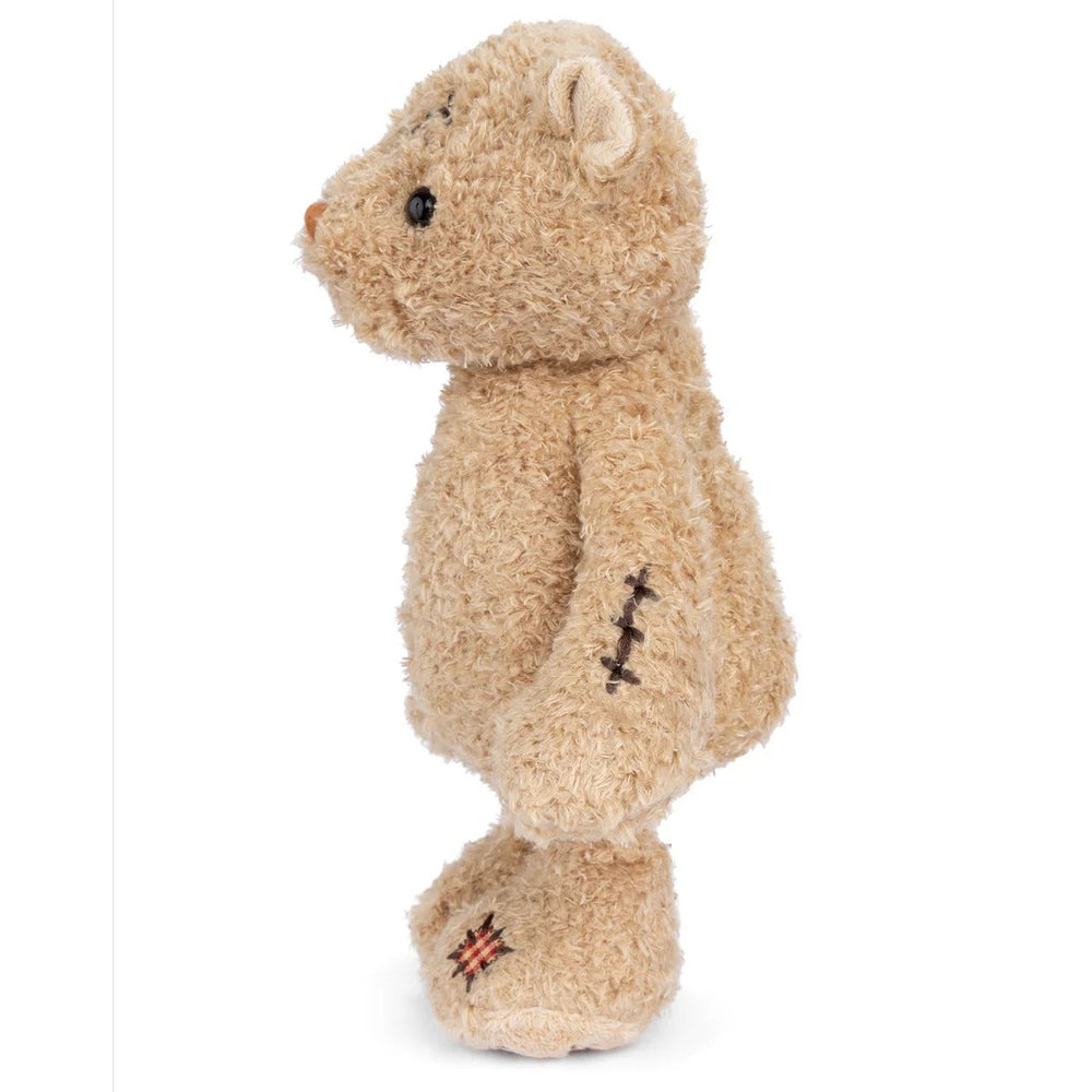 Bukowski Bears Nobody is Perfect stuffed bear; beige plush with visible arm stitches and patched paw.