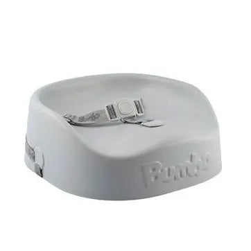 Bumbo Booster Seat, white plastic with gray safety belt, shown on a surface ready for baby feeding