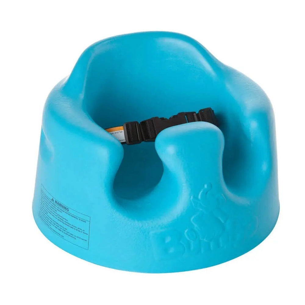 Bumbo Floor Seat blue infant chair with adjustable safety strap secured for upright support.