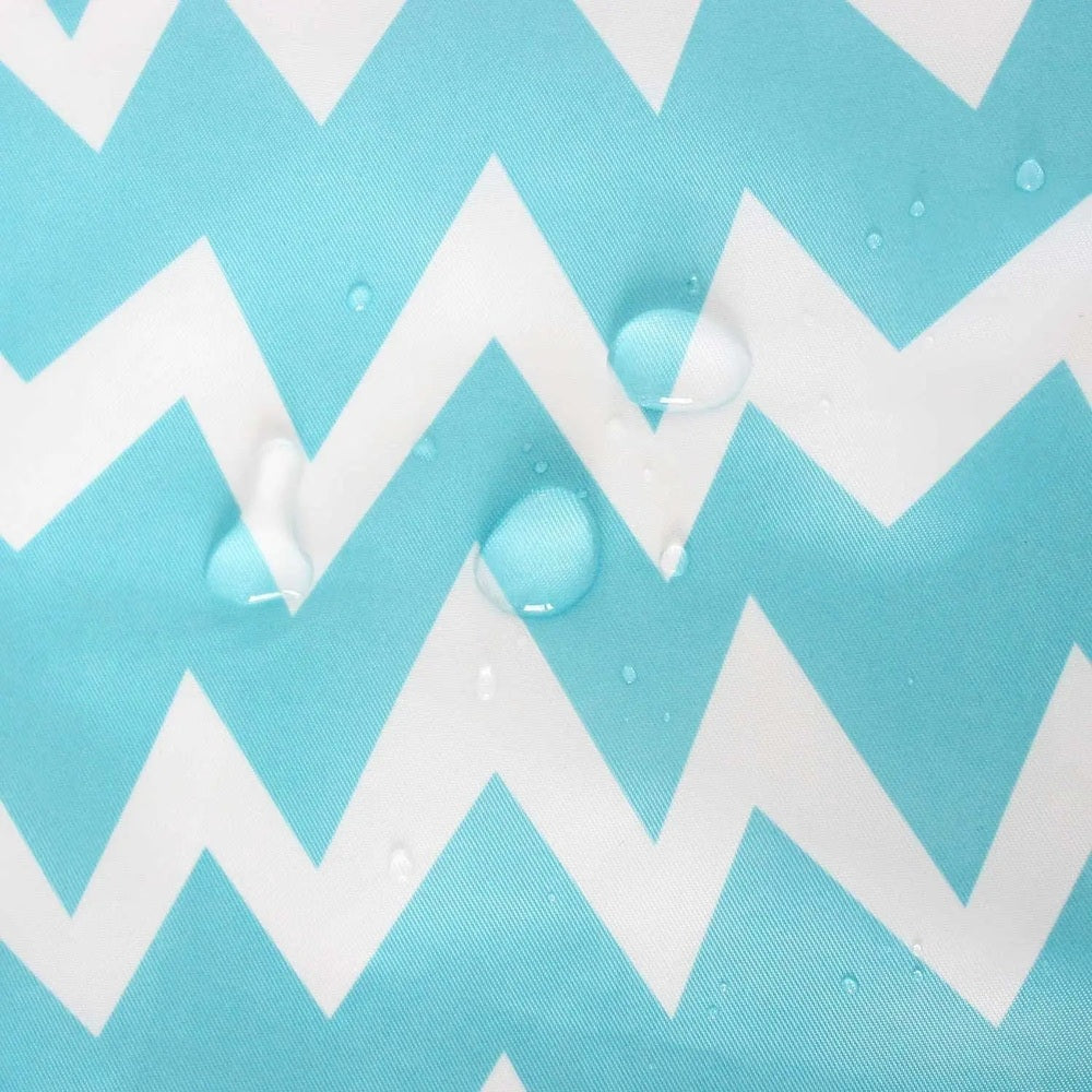 Bumkins Sleeved Bib in turquoise chevron, snaps closed, water droplets bead on