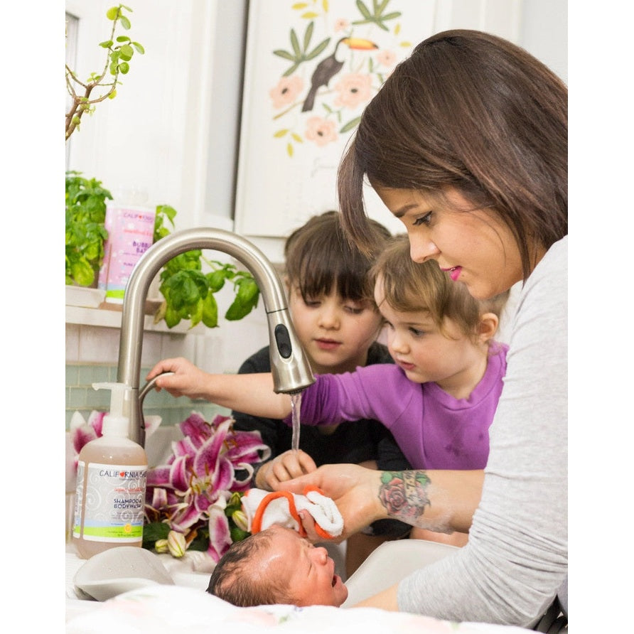 California Baby Super Sensitive Shampoo & Bodywash fragrance-free, 8.5 oz bottle shown in a family bath scene