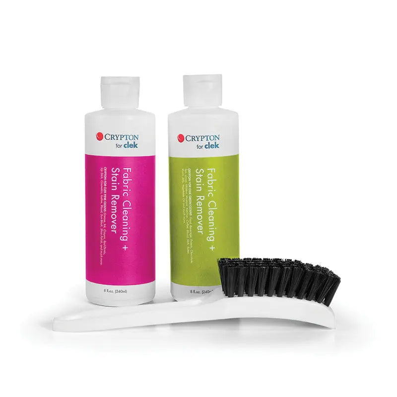 CLEK Clek Cleaning Kit: pink and green fabric cleansing bottles beside a curved brush, ready for stain removal.