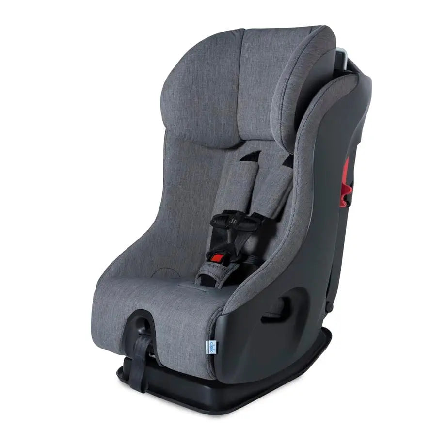 Clek Fllo convertible car seat in gray fabric with a securely fastened 5-point harness on a sturdy base.