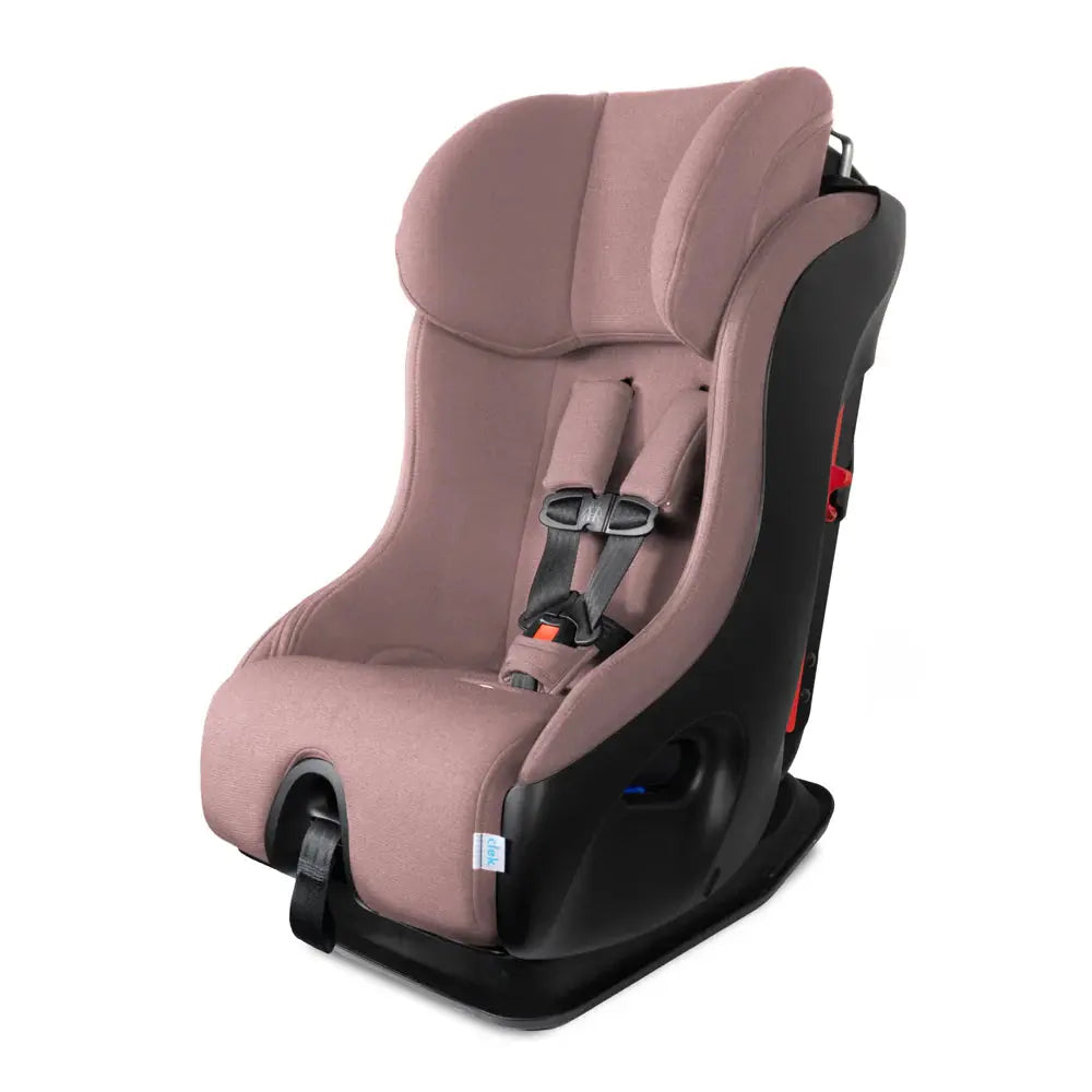 Clek Fllo convertible car seat in pink fabric, featuring a 5-point harness, mounted on a black base.