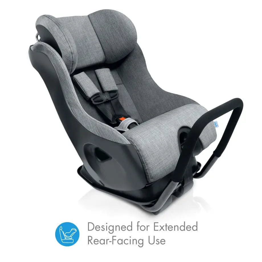Clek Fllo convertible car seat in gray fabric mounted on a base, designed for extended rear-facing use.