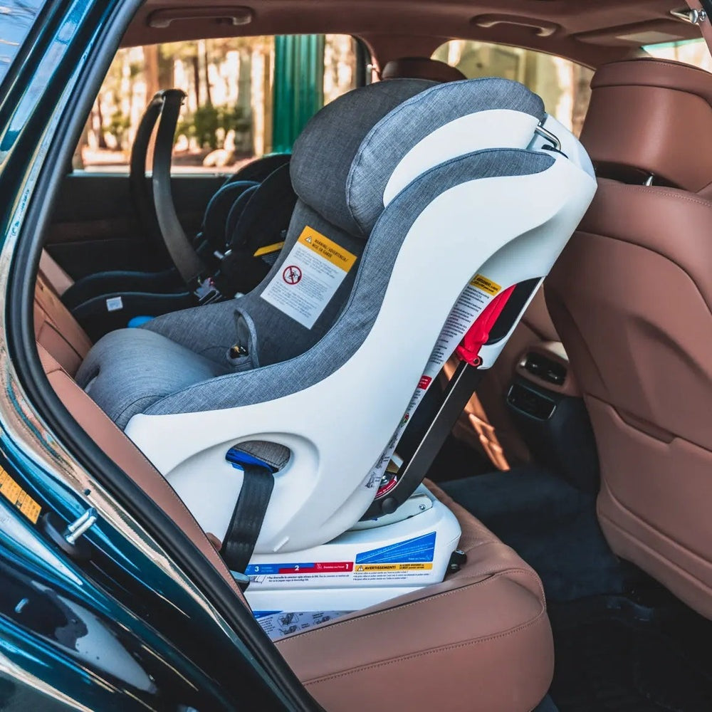 Clek Convertible Car Seat Foonf in gray fabric with white shell securely installed on rear seat.
