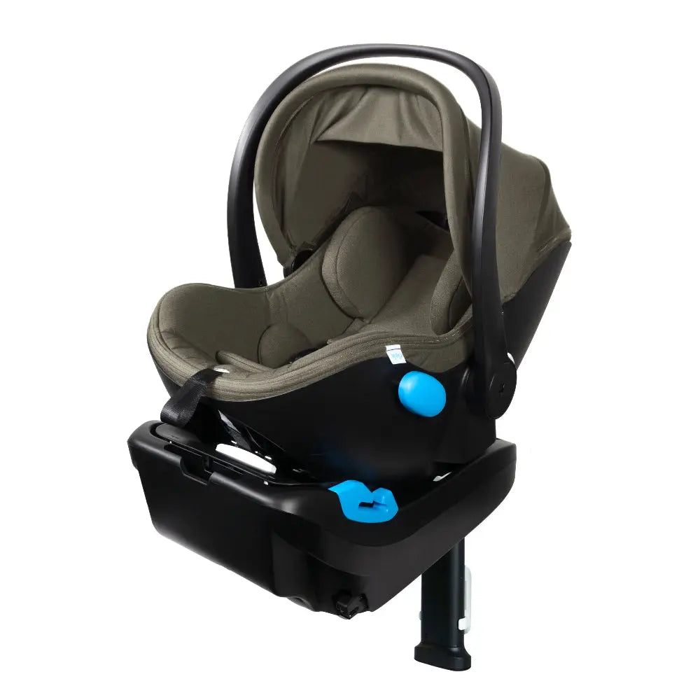 Clek Liing infant car seat in gray fabric on a black base, with a raised carry handle and blue adjustment knob.