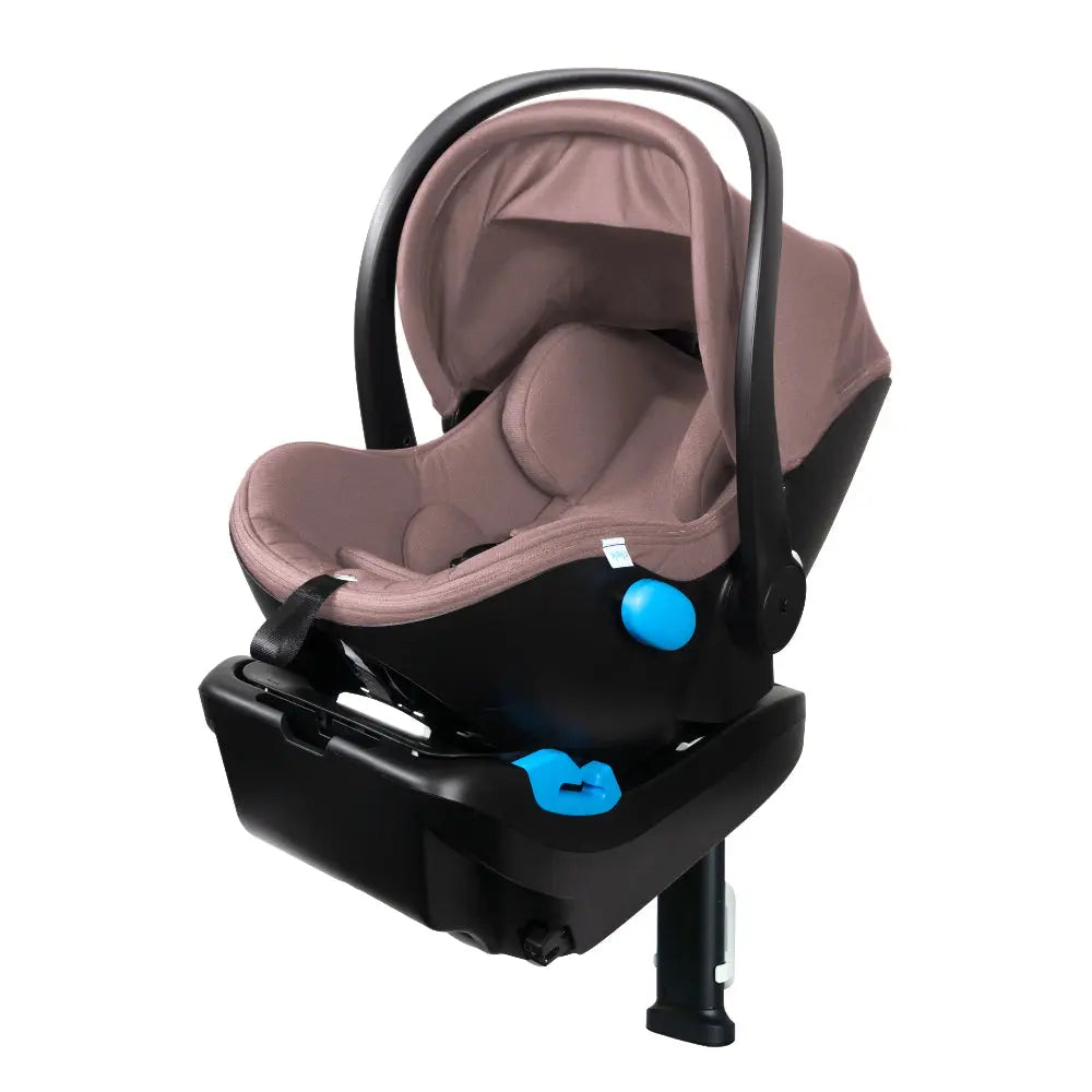 Clek Liing infant car seat in tan fabric on a black base with blue adjustment knobs and carry handle.
