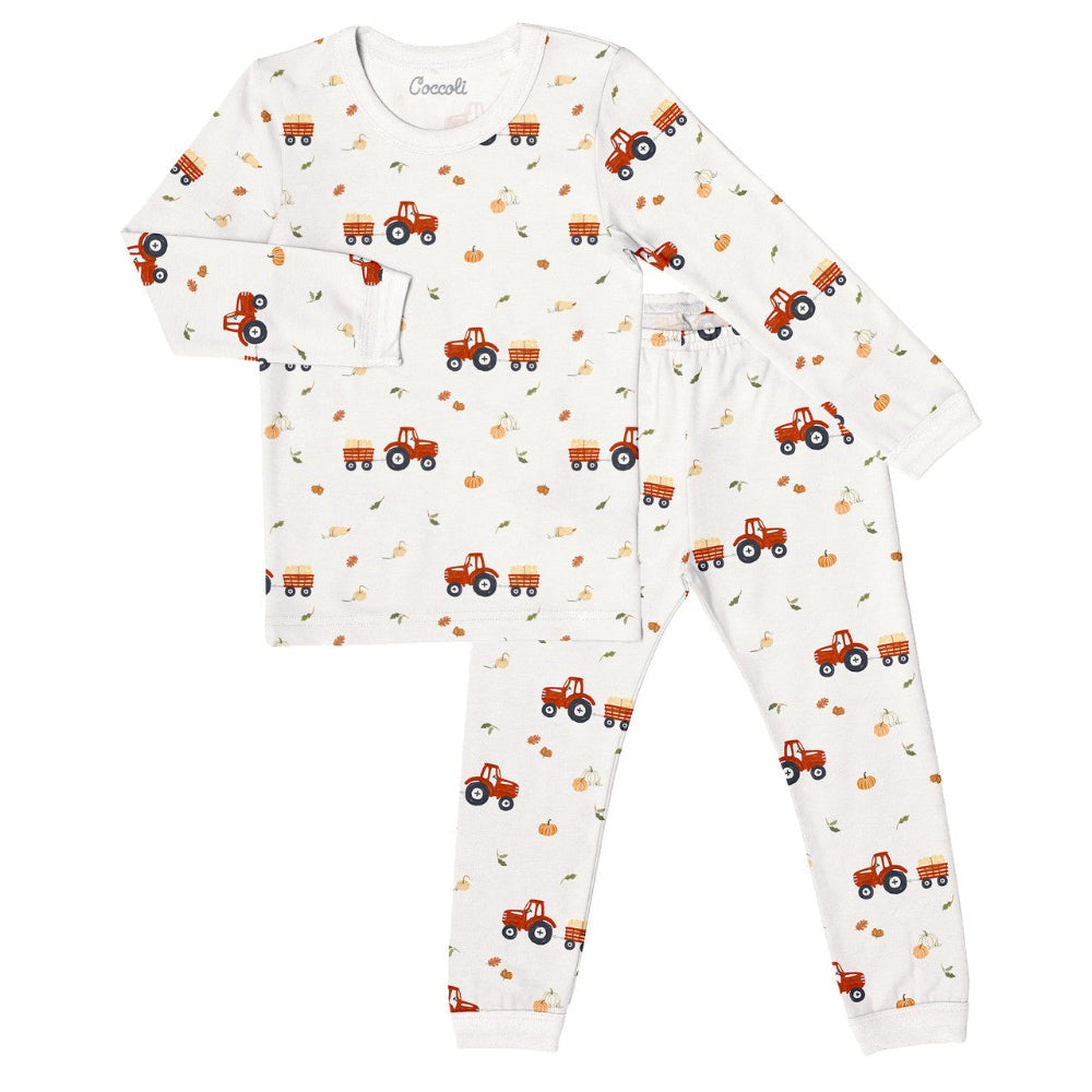 Coccoli kids long-sleeve pajama set in oat milk white with red tractor prints, cotton TENCEL™ Modal.