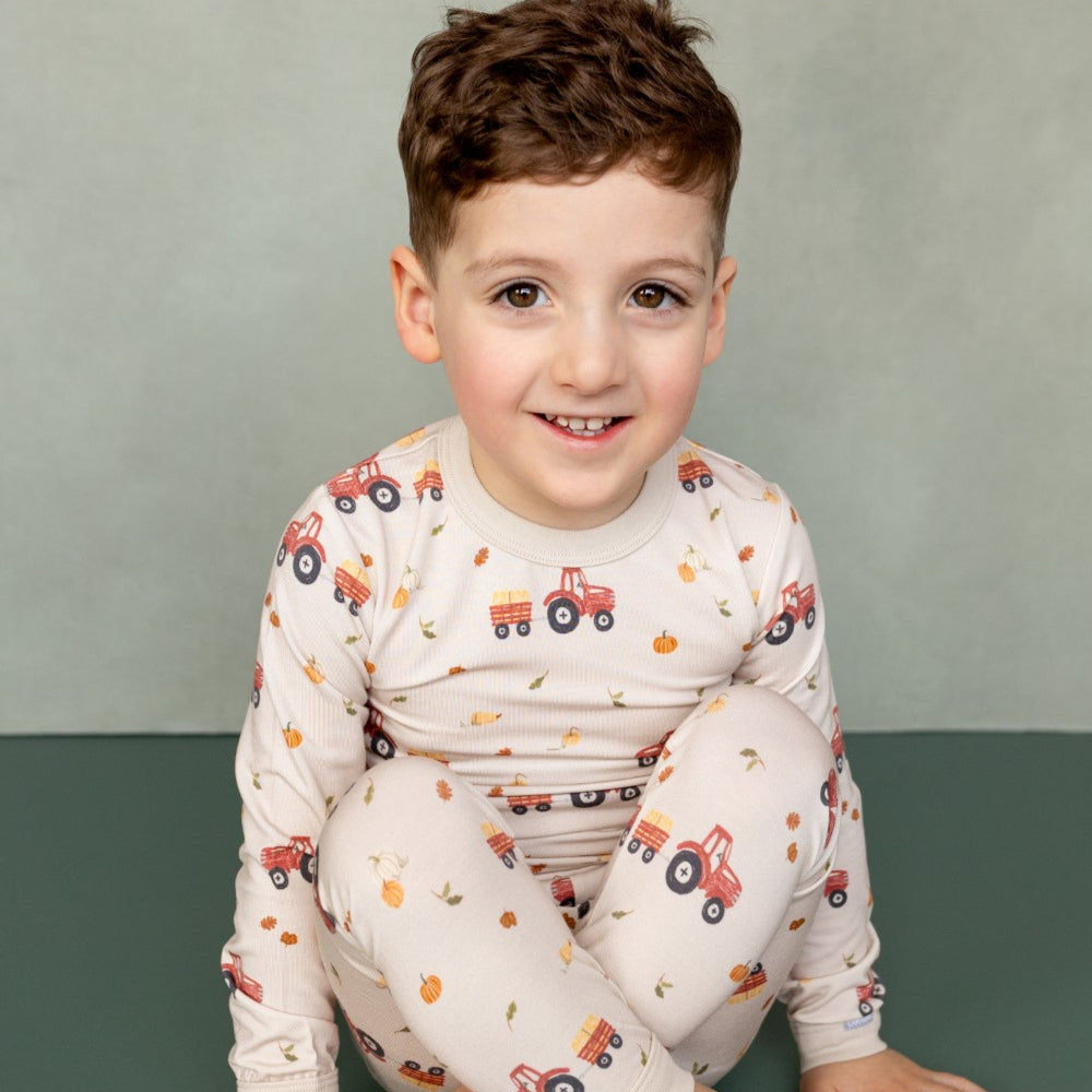 COCCOLI kid long-sleeve pajama set in oat milk with tractor print; cotton TENCEL Modal fabric