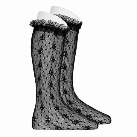 Condor Ceremony Silk Lace Knee High Tights Black worn on two legs, sheer floral lace with white lace frill cuffs.