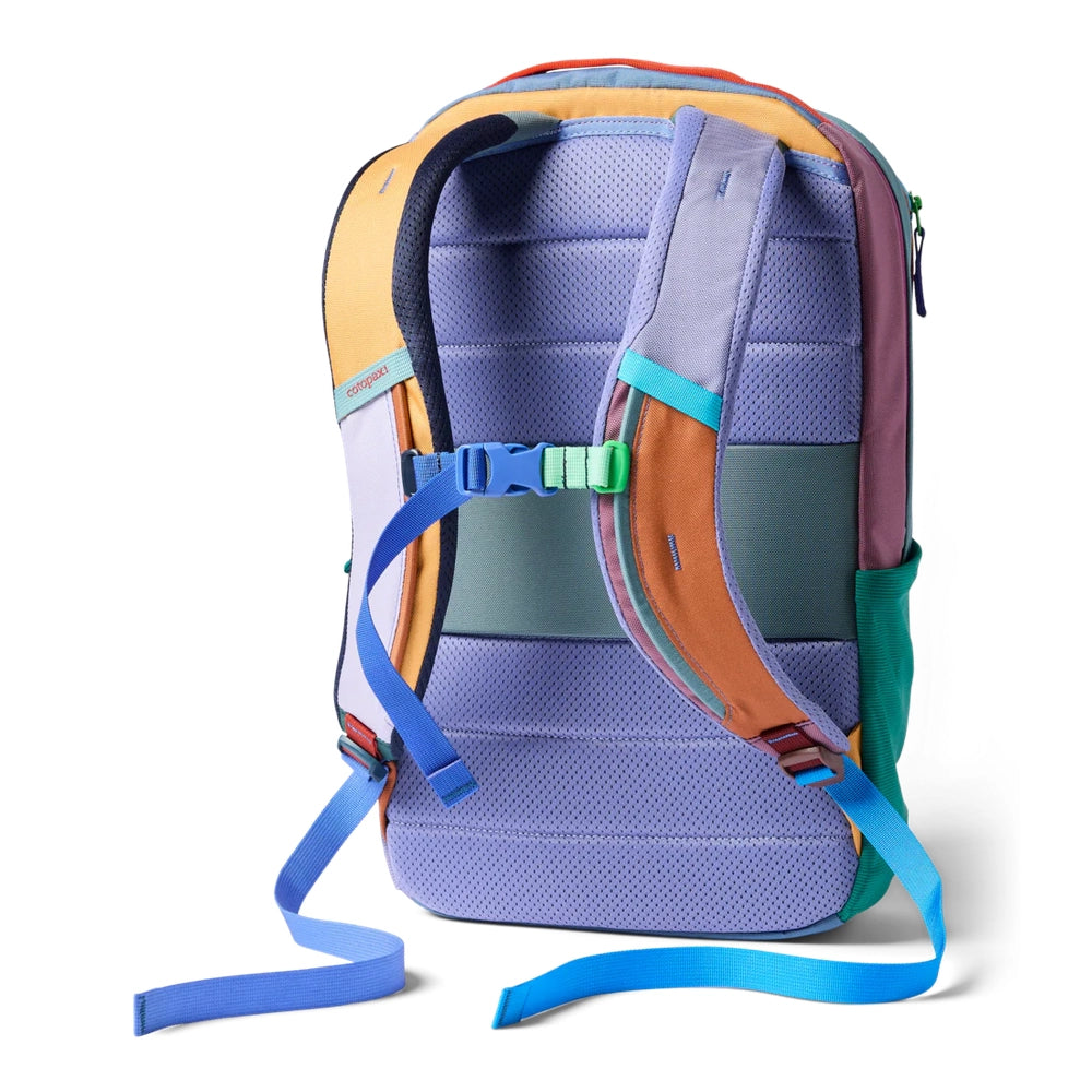 Cotopaxi Allpa 18L Daypack in multicolor lavender with blue straps and orange/teal panels, rear view