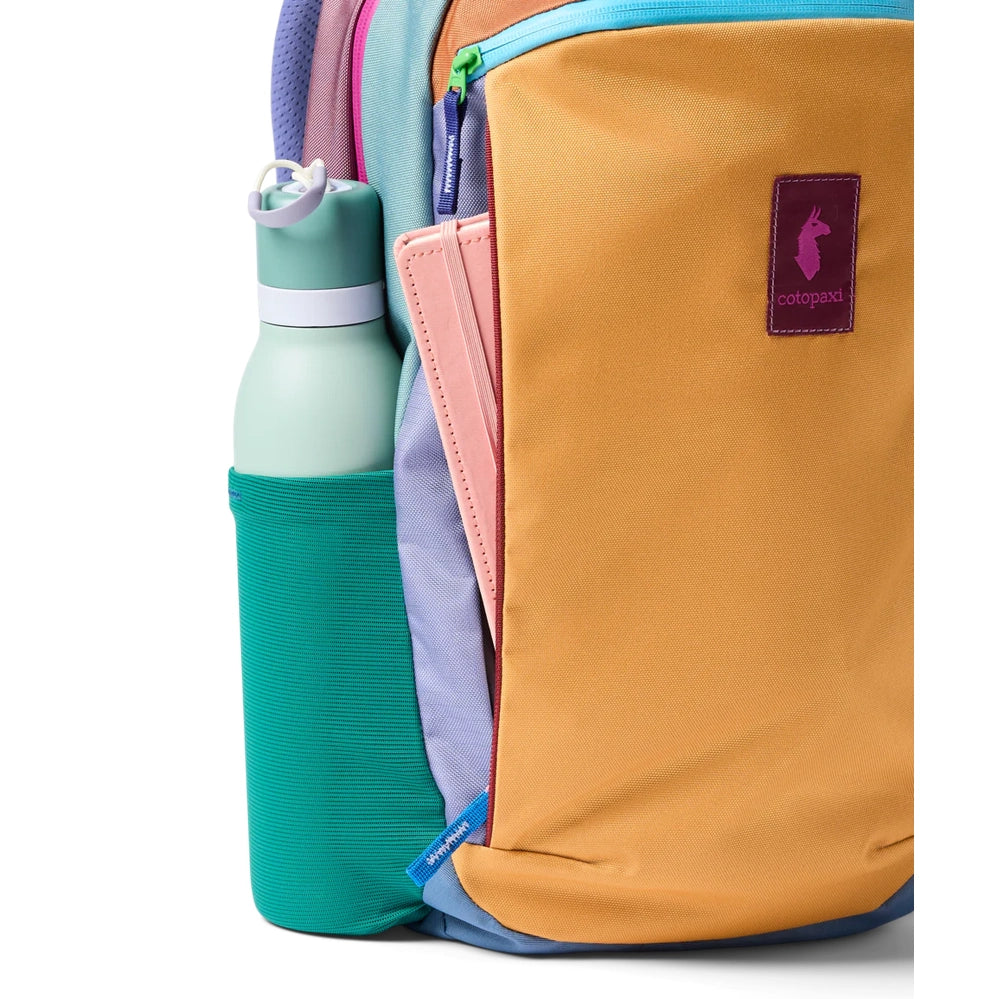 Cotopaxi Allpa 18L Daypack in orange with teal side bottle pocket and pink strap, purple logo patch.