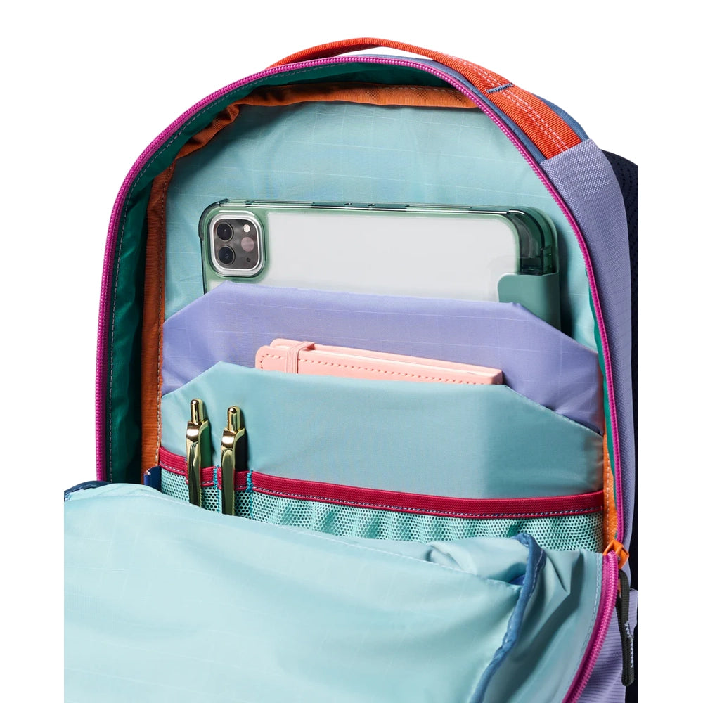 Cotopaxi Allpa 18L Daypack in turquoise interior with lavender pockets and pink zipper accents.