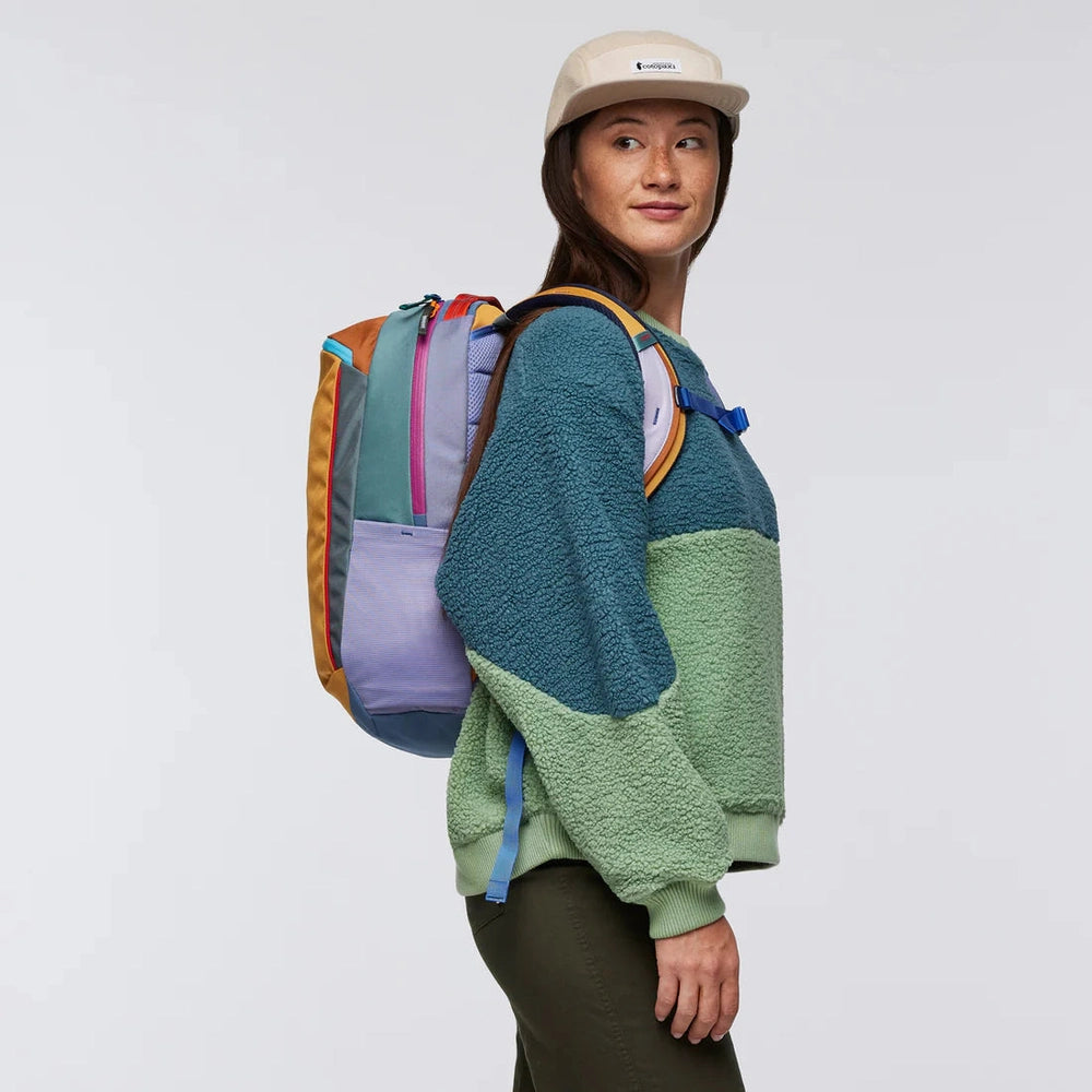 Cotopaxi Allpa 18L Daypack in multi-color block panels with teal, lavender, mustard, and orange accents
