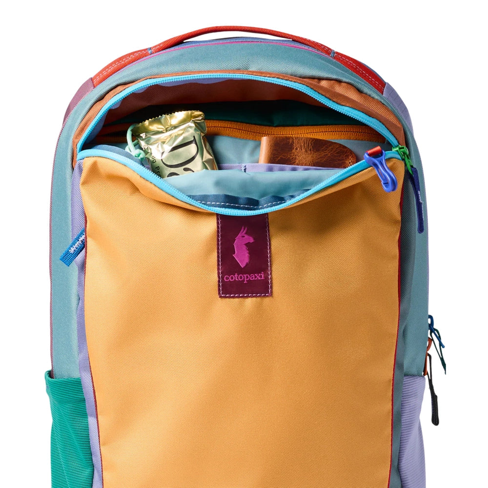 Cotopaxi Allpa 18L Daypack in teal body with orange front pocket and purple logo patch.