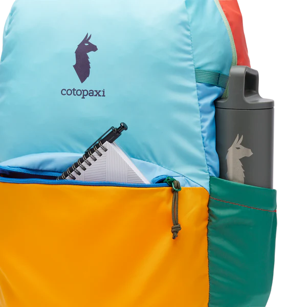 Cotopaxi Chiquillo Daypack in turquoise top panel with orange front pocket and teal side pocket with water bottle.