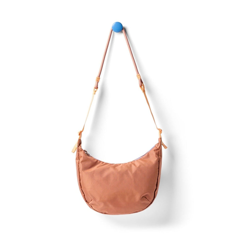 Cotopaxi Trozo 8L Shoulder Bag Cada Dia in Terracotta with braided pink rope strap
